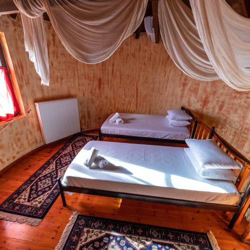 Cozy and well-appointed triple bedroom with rustic decor in Vintage Stone House, a vacation rental in Greece